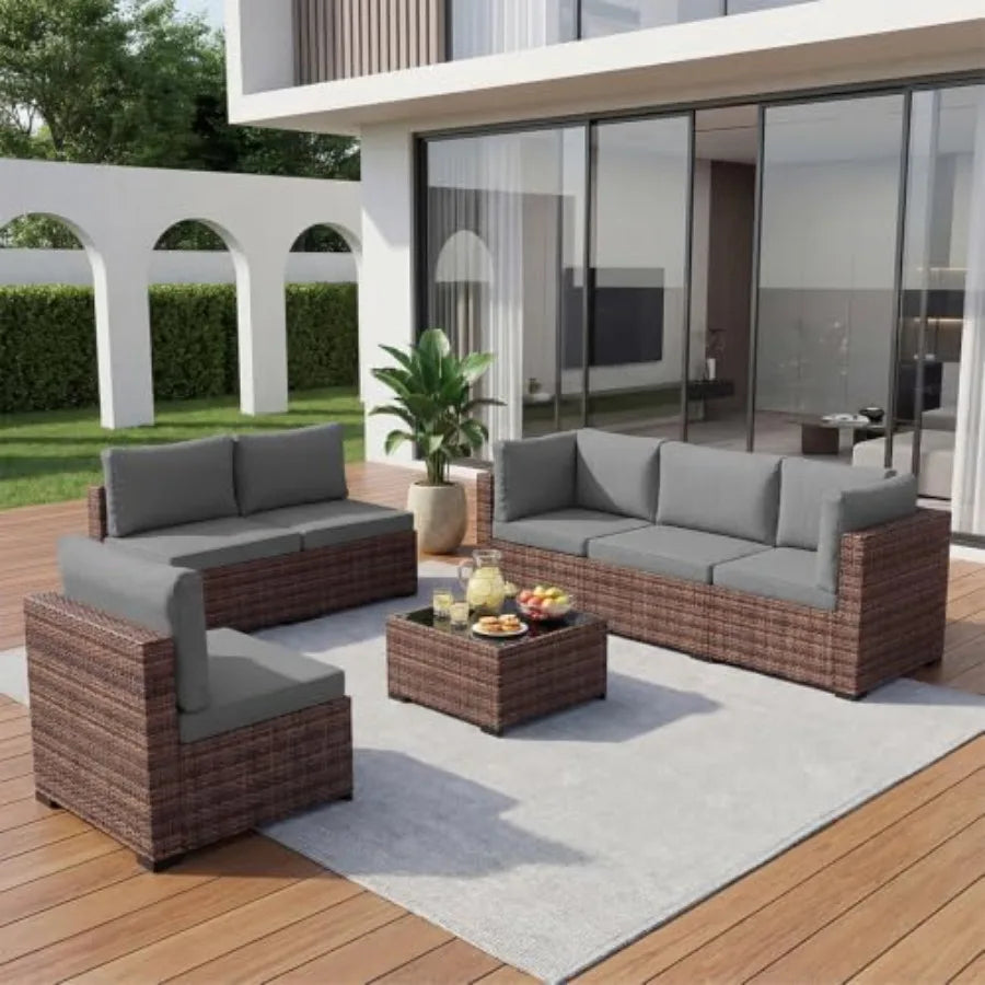 Outdoor patio furniture set: wicker rattan sectional sofa with coffee table and grey cushions, weather-resistant synthetic ratt